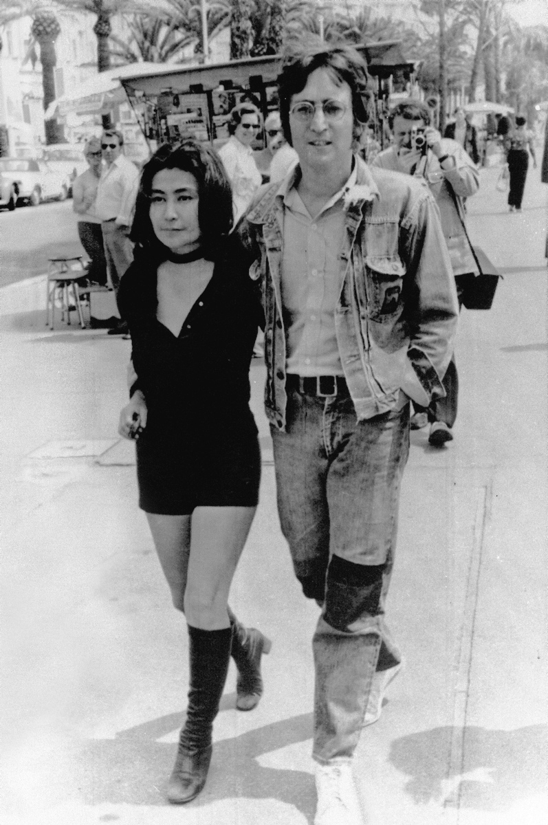 John Lennon and his wife Yoko Ono walk on the Croisette in Cannes on May 5, 1971. They are presenting their films 