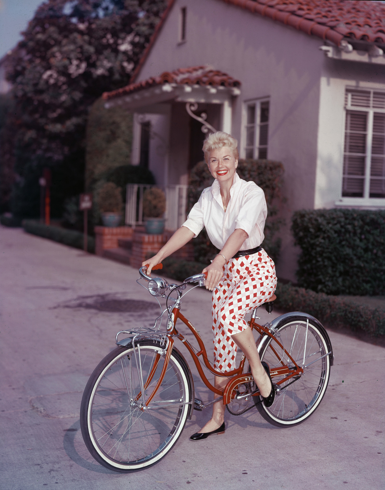 Doris Day poses on a red Schwinn bicycle circa 1955.