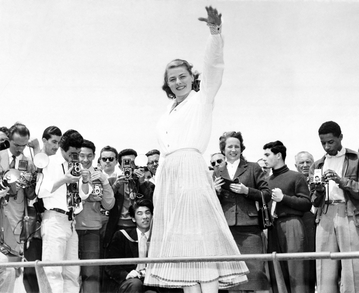 Ingrid Bergman is snapped from all sides by a crowd of photographers at Cannes, France on May 16, 1956.