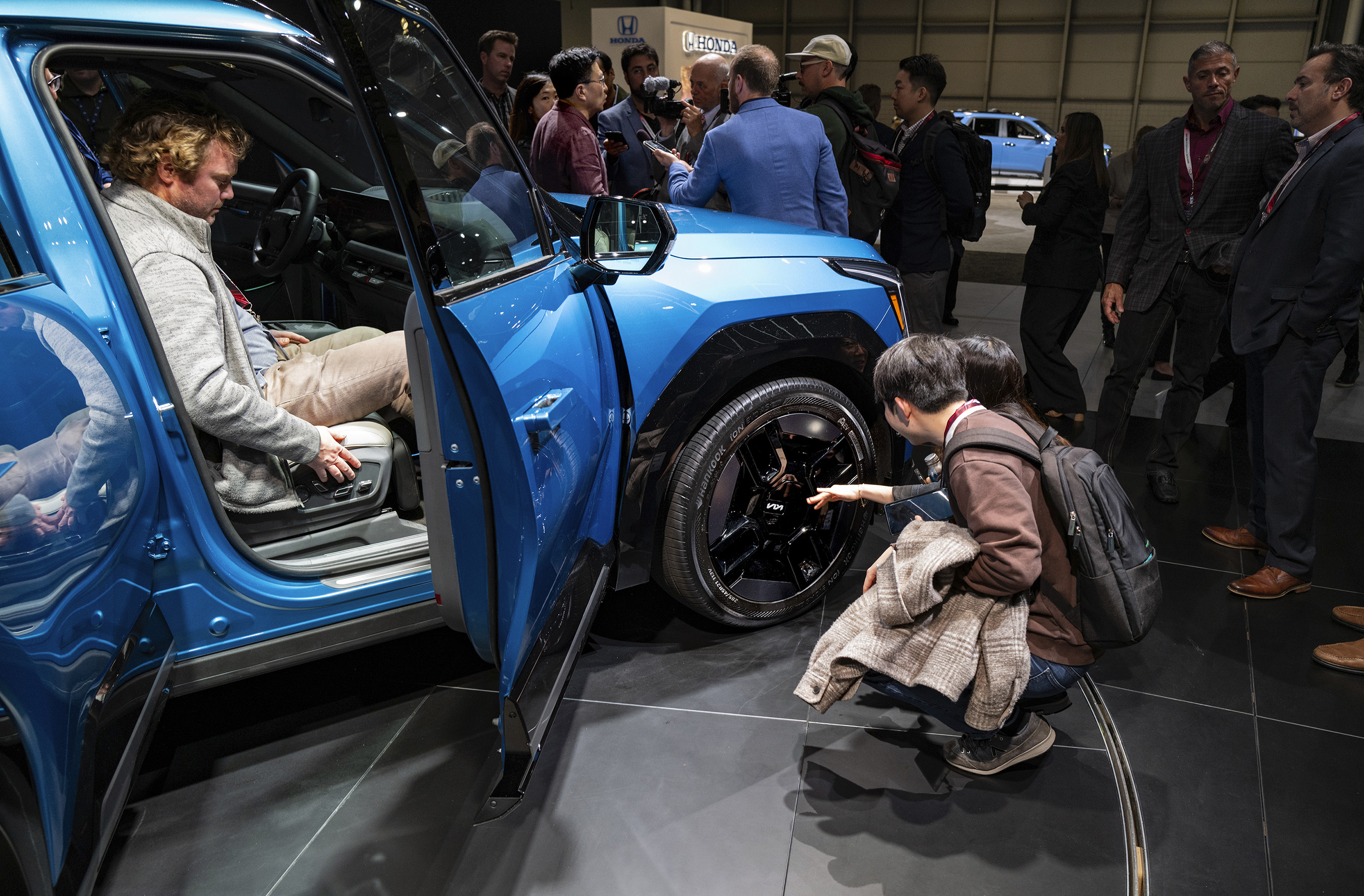 People look over the KIA EV9 after it was introduced at the New York International Auto Show in New York on Wednesday, April 5, 2023.