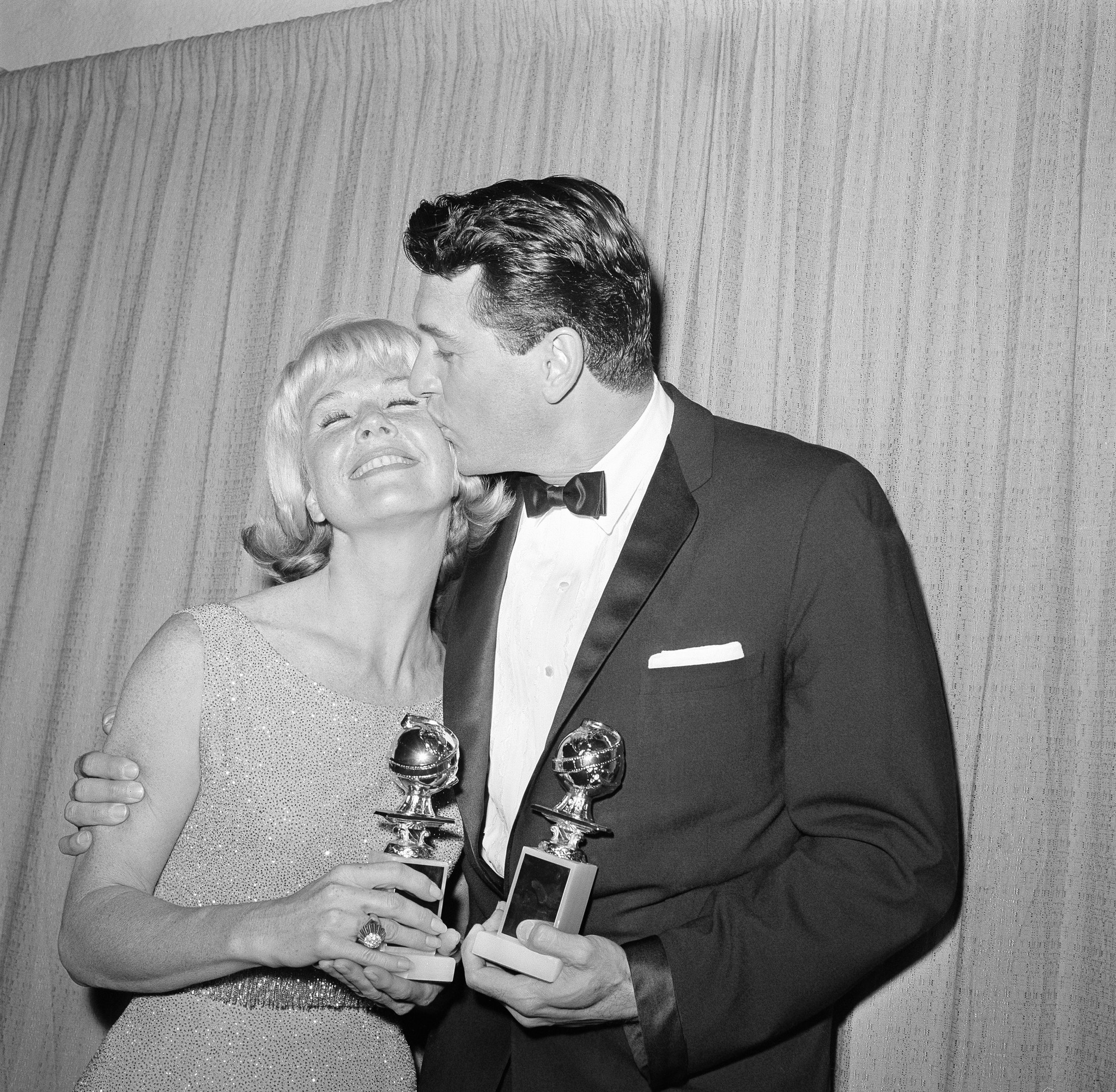 Actor Rock Hudson puts an arm around actress Doris Day on March 5, 1963, in Los Angeles, as they pose with their Golden Globes after being named world film favorites at the 20th Golden Globe Awards by the Hollywood Foreign Press Association.