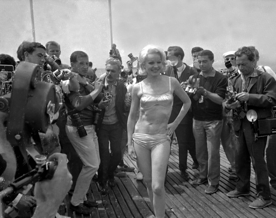 Actress and sex symbol Carroll Baker was surrounded by photographers at Cannes while wearing a bikini.