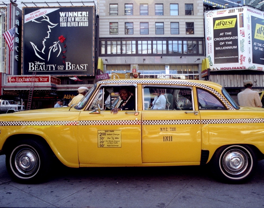Taxicab driver Earl Johnson sits in his cab, which was the last Checker cab to be driven in New York, while it is on display at Duffy Square in Times Square.