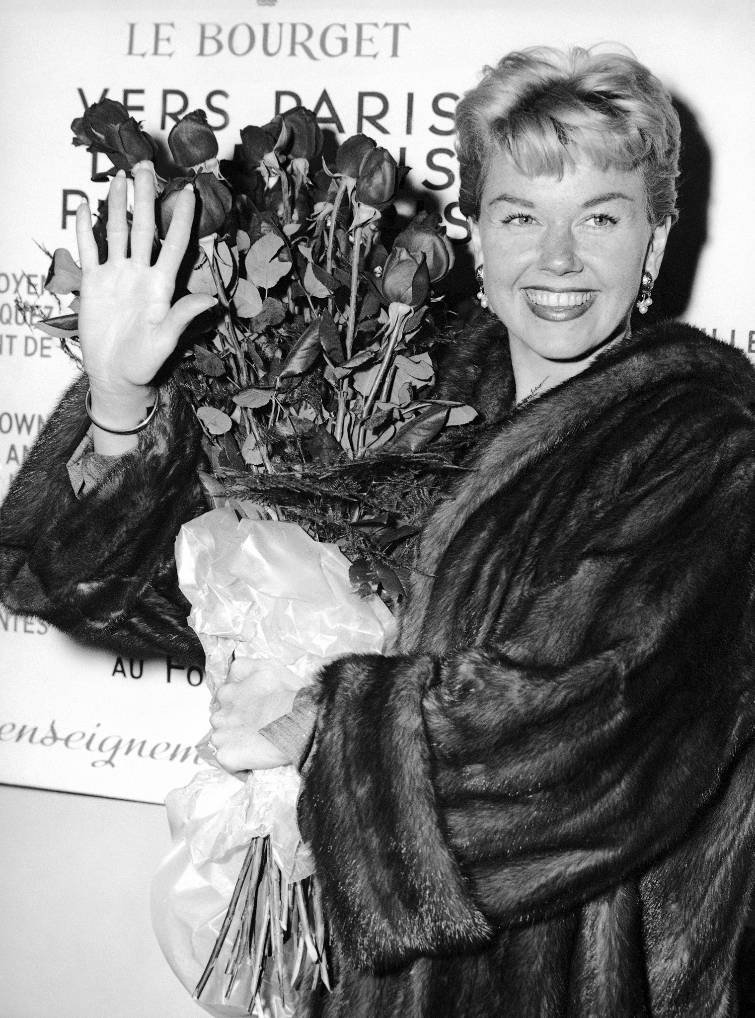 American actress and singer Doris Day holds a bouquet of roses at Le Bourget Airport on April 15, 1955, in Paris, after flying in from London. Day planned to spend a week in Paris before traveling to the Cannes Film Festival.