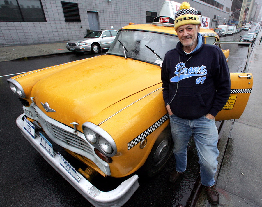 Ray Kottner stands next to his Checker cab. Kottner has been a taxi driver for more than 50 years.