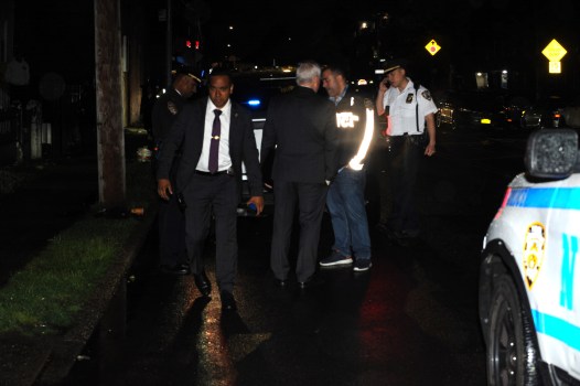 Police on the scene where a child was shot on Wednesday in front of NYCHA's South Jamaica Houses. (Sam Costanza for the New York Daily News)